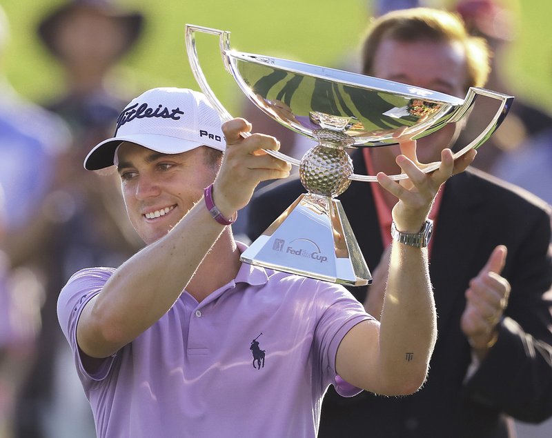 The Associated Press JUSTIN REWARDS: Justin Thomas holds the trophy on Sept. 24, 2017, for winning the FedEx Cup after the Tour Championship at East Lake Golf Club in Atlanta.