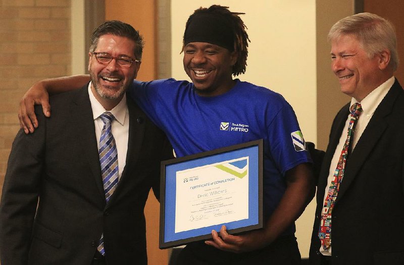Deric Williams (center), a trainee mechanic, poses with Rock Region Metro executive director Charles Frazier (left) and training coordinator David Fowler after a graduation ceremony for its new ambassadors at the agency’s North Little Rock headquarters.