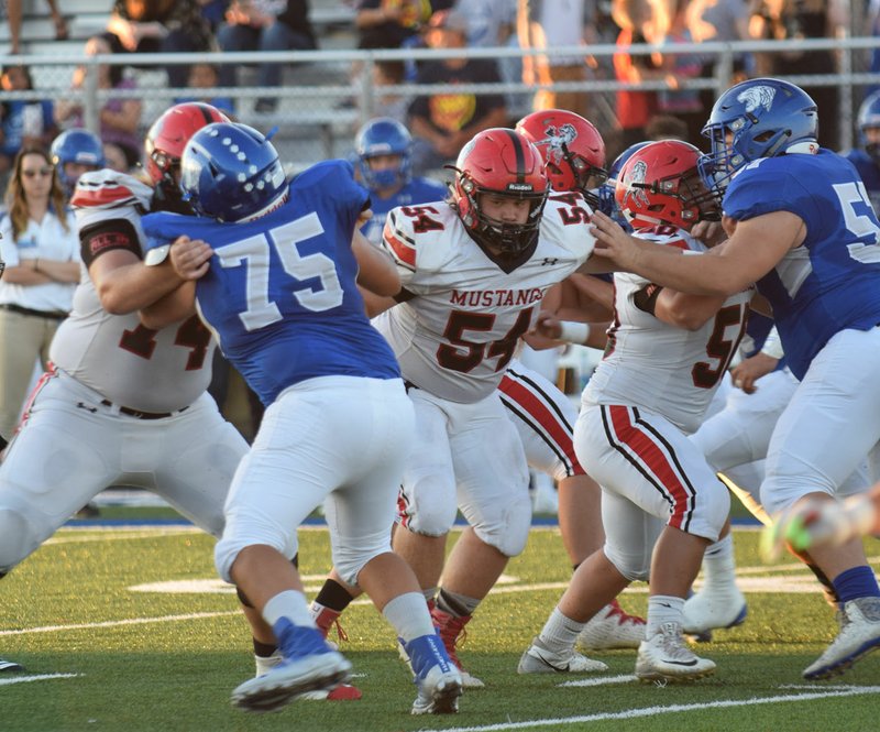 RICK PECK/SPECIAL TO MCDONALD COUNTY PRESS McDonald County linemen Elliott Wolfe (74), Tanner Harnar (54) and Kaidan Campbell (50), along with Will Gordon and Tryston Leach -- not shown, paved the way for Oakley Roessler to run for 287 yards in the Mustangs' 35-28 loss to Hollister on Sept. 14 at Hollister High School.