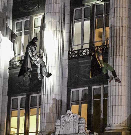 The Sentinel-Record/Grace Brown CAPED CRUSADER: Batman and Robin rappel down the front of The Waters hotel in downtown Hot Springs Tuesday night on their way to this weekend's Spa-Con. The event, staged by Visit Hot Springs, was designed to promote the third annual multigenre convention, which will feature Pam Grier, Sean Maher and Butch Patrick as celebrity guests.