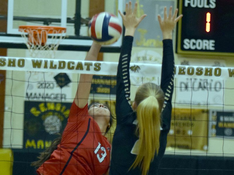 RICK PECK/SPECIAL TO MCDONALD COUNTY PRESS McDonald County's Nicole Salas spikes over Neosho's Brianna Keho during the Lady Mustangs 15-25, 25-13, 25-12 loss on Sept. 17 at Neosho High School