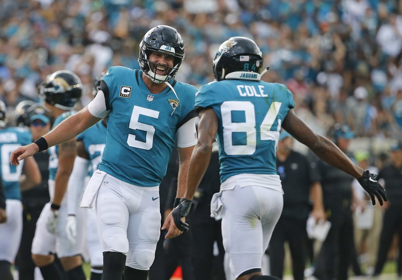 In this Sunday, Sept. 16, 2018, file photo, Jacksonville Jaguars quarterback Blake Bortles (5) celebrates his touchdown pass to wide receiver Keelan Cole (84) during the first half of an NFL football game against the New England Patriots in Jacksonville, Fla.  (AP Photo/Stephen B. Morton)