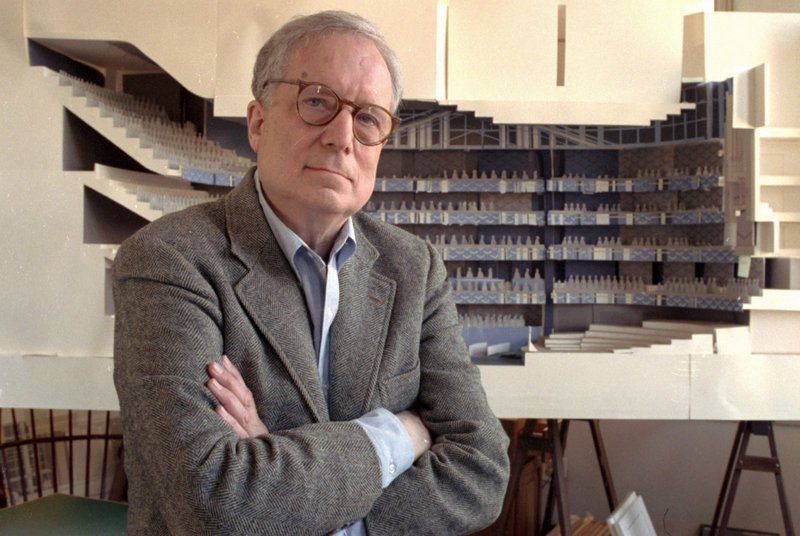 FILE - In this April 1991 file photo, architect Robert Venturi poses in his office in the Manayunk section of Philadelphia, with a model of a new hall for the Philadelphia Orchestra in background. Venturi, who turned austere modern design on its ear, ushering in postmodern complexity with the dictum &quot;Less is a bore,&quot; has died. He was 93. His family released a statement on his firm&#x2019;s website saying Venturi died at home in Philadelphia on Tuesday, Sept. 18, 2018, after a brief illness, and was surrounded by his wife and son. (AP Photo/George Widman, File)