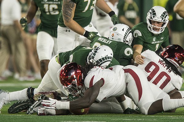 Arkansas defensive lineman McTelvin Agim recovers a fumble during a game against Colorado State on Saturday, Sept. 8, 2018, in Fort Collins, Colo.