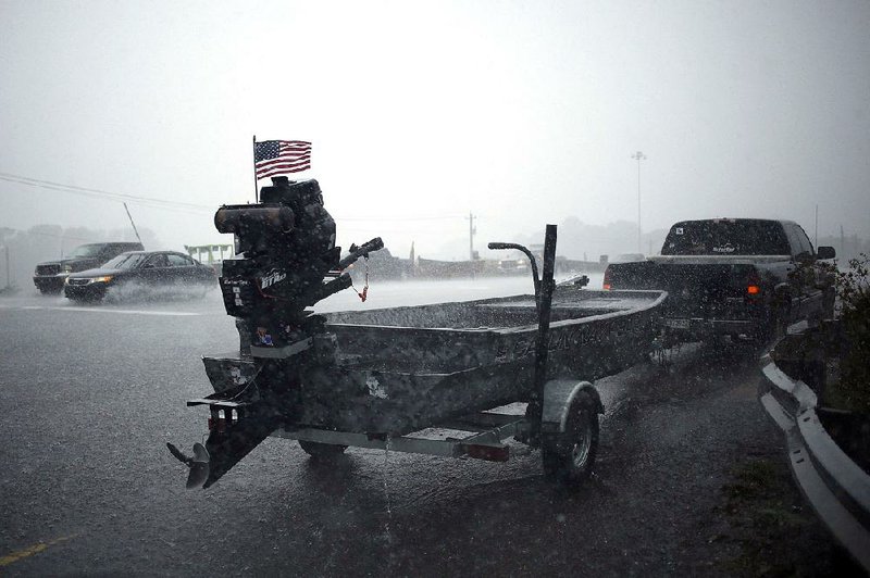 An American flag flies on a Cajun Navy boat during a downpour from Tropical Depression Florence in Lumberton, N.C., on Sunday. North Carolina confronted a spiraling statewide crisis on Sunday as Florence slowly ravaged the region, flooding cities, endangering communities from the coastline to the rugged mountains, and leading to more than 1,000 rescues.