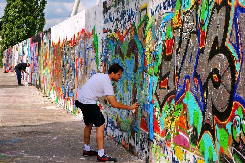 The wall that once separated East and West Berlin is now a place where people come with spray paint to create wild and crazy art. 