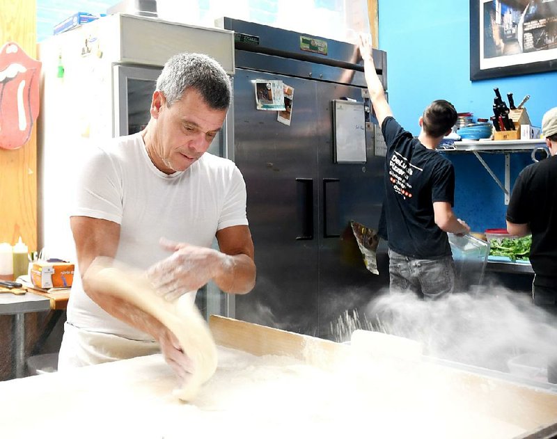 The Sentinel-Record/Mara Kuhn - Anthony Valinoti, owner of DeLuca's Pizzeria prepares crusts on Thursday, Jan. 26, 2017.