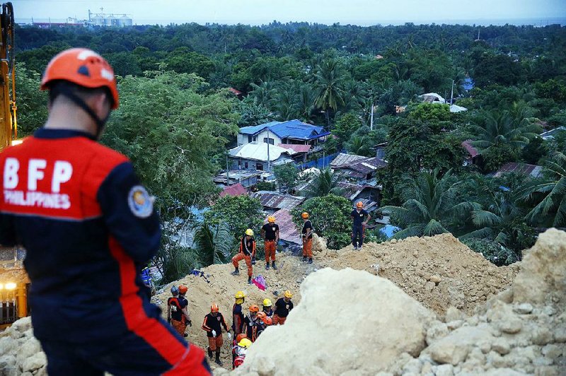Rescuers search for survivors in the jumble of landslide debris and buried homes Thursday in Naga city in the central Philippines province of Cebu, where at least 64 people remained missing. 
