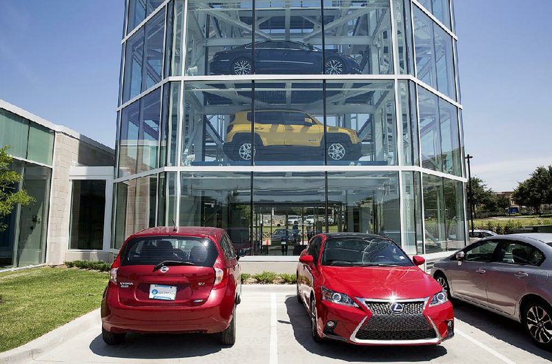 Vehicles sit parked outside the Carvana Co. car vending machine in Frisco, Texas, in the summer of 2017. 