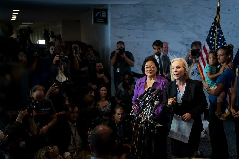 Democratic Sens. Mazie Hirono (left) of Hawaii and Kirsten Gillibrand of New York hold a news conference Thursday on Capitol Hill. “What is happening with the Judiciary Committee, really, I would call it a railroad job,” Hirono said of the confirmation process for Supreme Court nominee Brett Kavanaugh. Gillibrand said Senate Republicans’ ultimatum of a Monday hearing for Kavanaugh’s accuser was “bullying.” 
