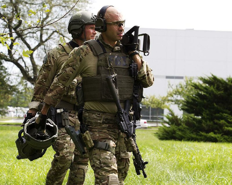 Heavily armed FBI agents help secure the scene after a shooting Thursday at an industrial business park in Harford County, Md. 