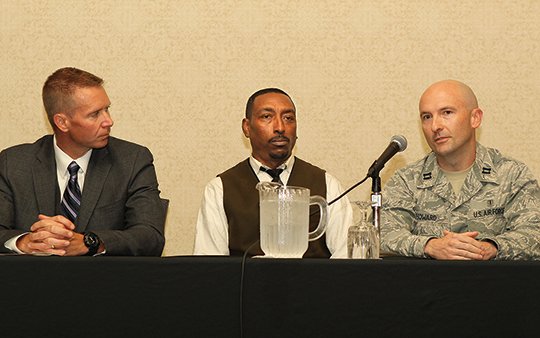 The Sentinel-Record/Richard Rasmussen HANDLING CRISIS: From left, Under Sheriff Jason Lawrence, of the Garland County Sheriff's Department, and Boyce Mitchell, of Ouachita Behavioral Health and Wellness, listen as Little Rock Air Force Base Capt. Scotty Howard talks during a panel discussion titled "Responding to Crisis" at the Moving Forward: Suicide Prevention Conference 2018 at the Arlington Resort Hotel &amp; Spa Thursday.