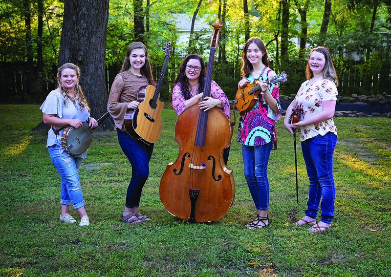 Enjoying a break during a recent rehearsal in Mountain View are members of the Twang All Girl String Band, from left, Lillyanne McCool, Gabi Pervis, Crystal McCool, Anna Caldwell and Rebecca Pool. The band will perform Sept. 30 in Fairfield Bay during the opening of the North Central Arkansas Foundation for the Arts and Education’s 2018-2019 concert season.