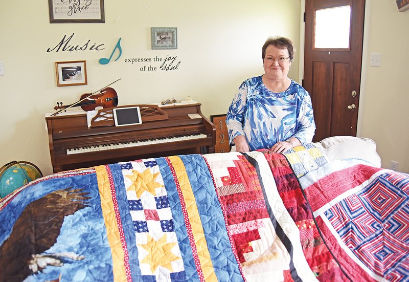 Susan Ashcraft made this quilt of valor, far left, for a friend whose brother served in the Navy in Vietnam and is now ill. The Frederick Van Patten chapter, National Society Daughters of the American Revolution, donated materials for the quilt, as well as for other quilts Ashcraft has made for veterans.
