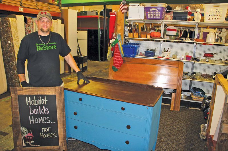 Shane Stubblefield, who works at the ReStore in Benton, stands next to a pair of items that are going to be auctioned off at this year’s Repurpose for a Purpose auction at the Benton Event Center on Thursday. Last year, the auction raised an estimated $8,000.
