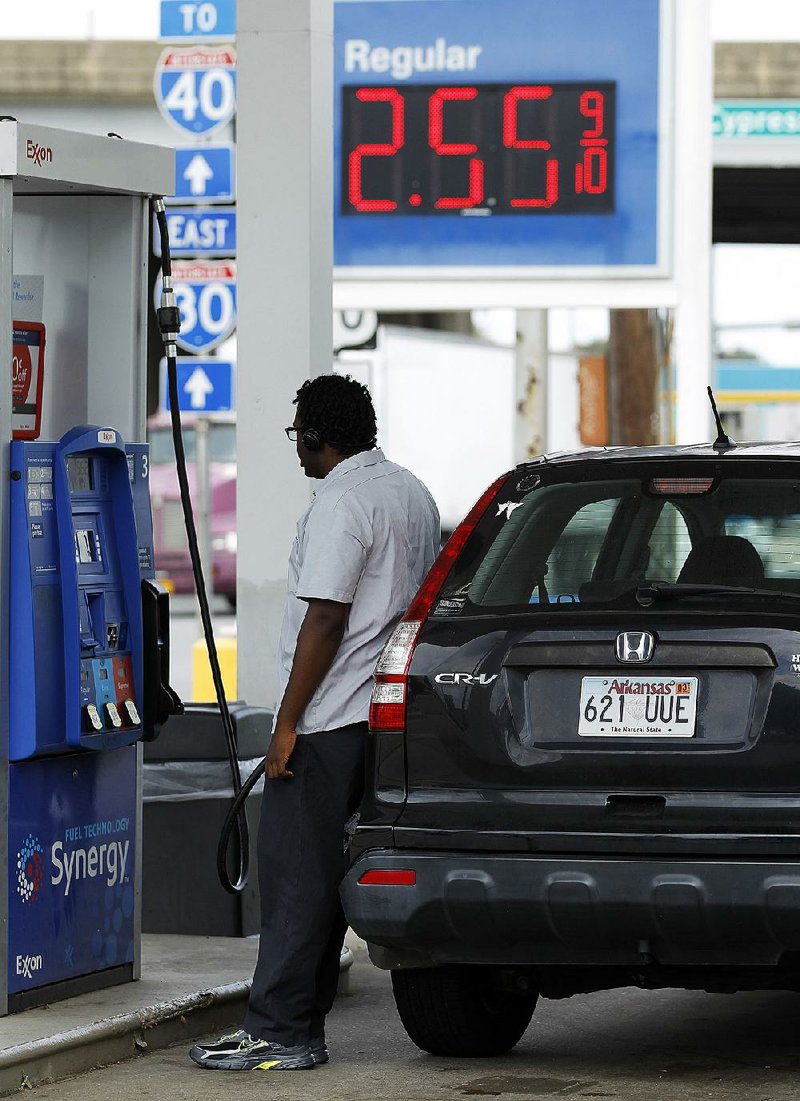 Marcellous Staten fuels up Friday at the Exxon on West Broadway in North Little Rock. The average price of gas in Arkansas is 22 cents a gallon higher than it was a year ago.