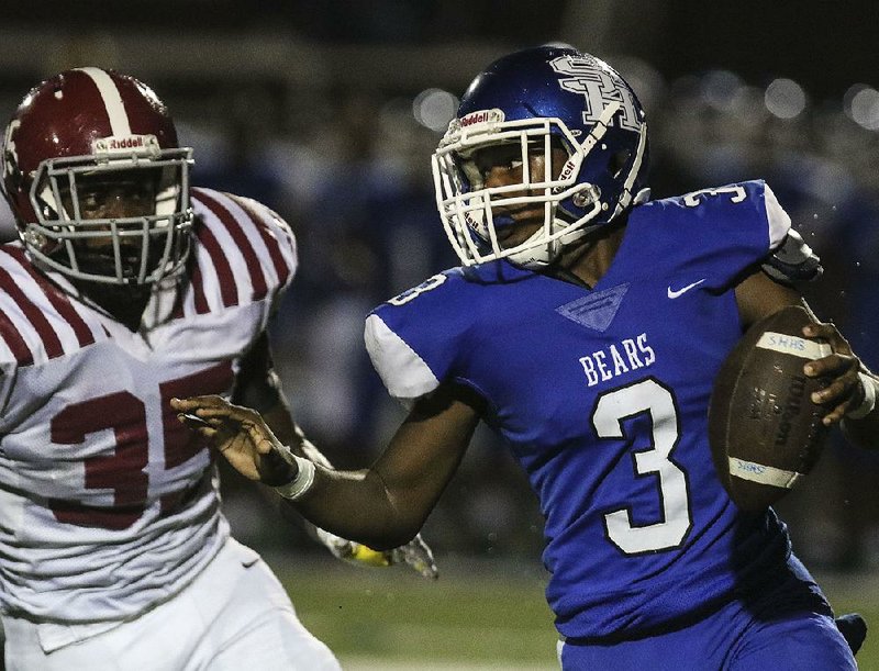 Sylvan Hills quarterback Dionte Hutchinson (3) scrambles out of the pocket as Pine Bluff linebacker Dau’zhu Thomas gives chase during Friday night’s game in Sherwood. 