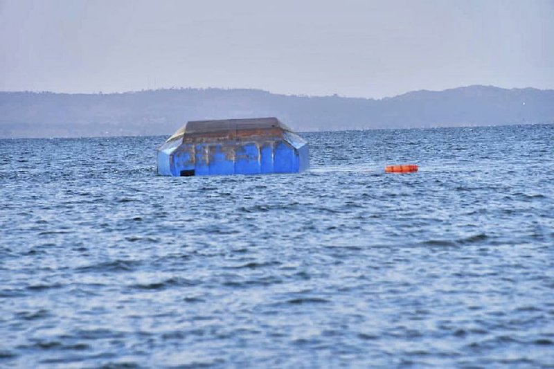 The upturned passenger ferry MV Nyerere floats Friday in the water near Ukara Island in Lake Victoria, Tanzania. The death toll rose to more than 130 after the ferry capsized Thursday. 