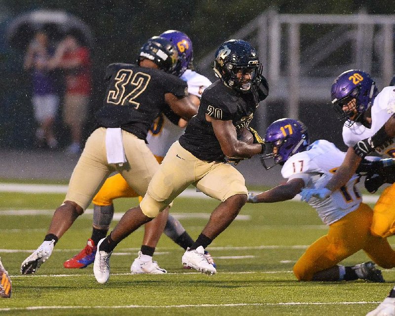 Joe T. Robinson  running back  Tyler Jones (20) runs through  a hole in the Fountain Lake defense during the Senators’ 28-6 victory on Friday. 