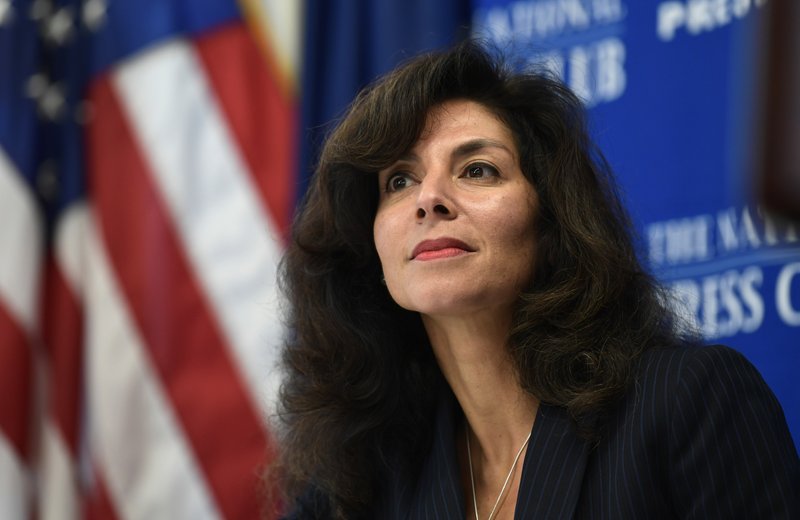 Ashley Tabaddor, a federal immigration judge in Los Angeles who serves as the President of the National Association of Immigration Judges, listens as she is introduced to speak at the National Press Club in Washington, Friday, Sept. 21, 2018, on the pressures on judges and the federal immigration court system. 