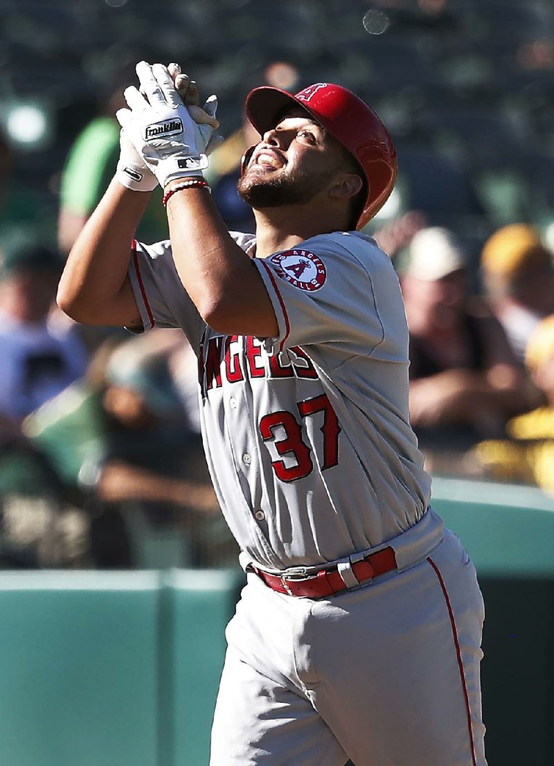 Francisco Arcia became the first modern day major league player to catch, pitch and hit a home run in the same game Thursday. But the Los Angeles Angels lost to Oakland 21-3.