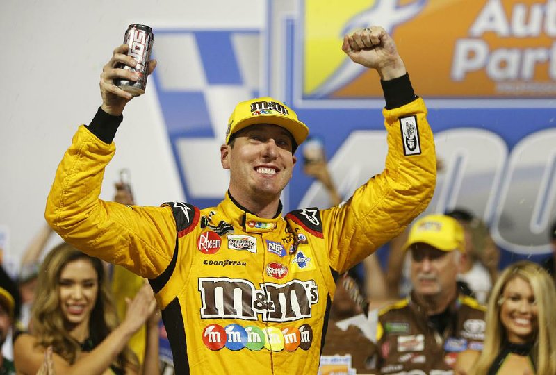 Kyle Busch (18) celebrates winning the NASCAR Monster Energy Series auto race in victory lane at Richmond Raceway in Richmond, Va., Saturday, Sept. 22, 2018.