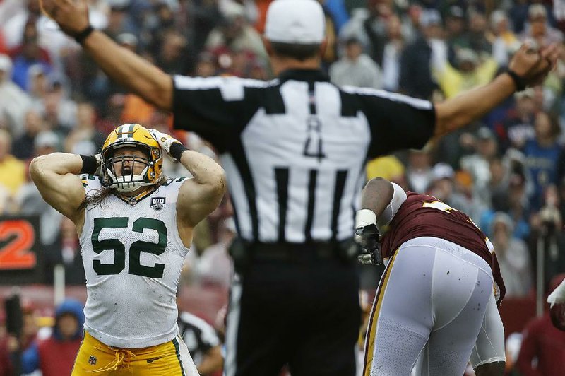 Green Bay Packers linebacker Clay Matthews (52) reacts to the roughing the passer penalty called on him after tackling Washington Redskins quarterback Alex Smith during the second quarter Sunday in Landover, Md.