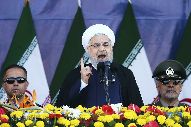 Iranian President Hassan Rouhani, shown speaking Saturday at a military parade in Tehran, claimed Sunday that a U.S. ally was responsible for a deadly attack on a similar parade in Ahvaz.