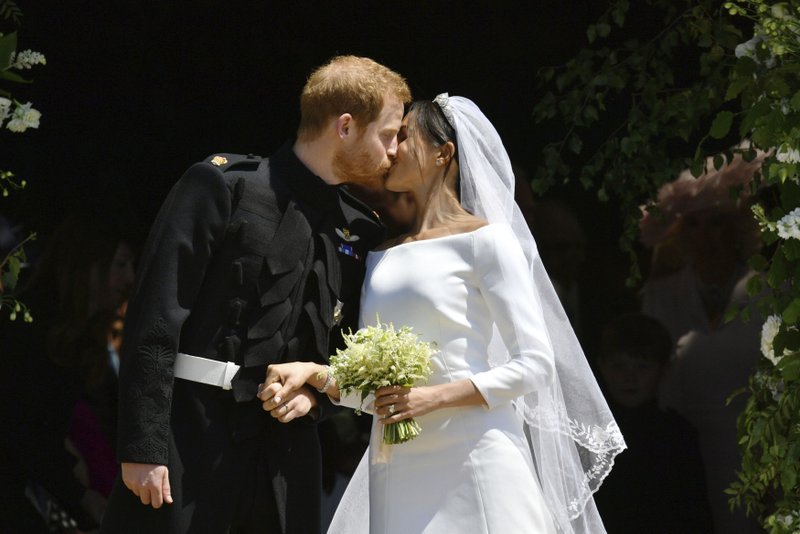 FILE - In this file photo dated Saturday, May 19, 2018, Britain's Prince Harry and Meghan Markle leave after their wedding ceremony at St. George's Chapel in Windsor Castle, in Windsor, England. Meghan Markle has revealed in a television documentary aired Sunday Sept. 23, 2018, that she had a piece of blue fabric from the dress she wore on her first date with Harry sewn into her wedding outfit. (Ben Birchhall/pool via AP, FILE)