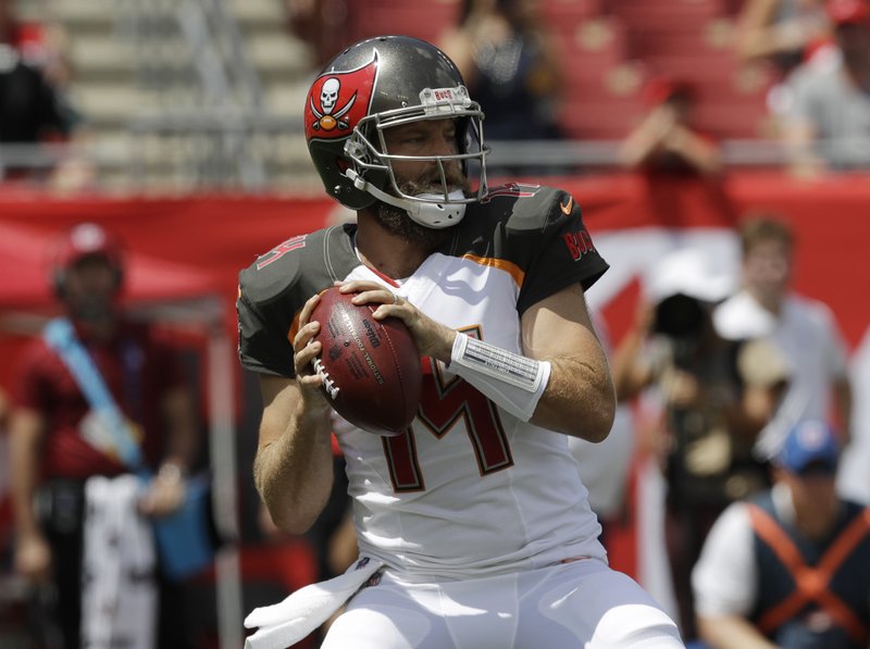 FILE - In this Sunday, Sept. 16, 2018 file photo, Tampa Bay Buccaneers quarterback Ryan Fitzpatrick (14) looks to pass during the first half of an NFL football against the Philadelphia Eagles in Tampa, Fla. So much for struggling without Jameis Winston. Ryan Fitzpatrick and a talented collection of playmakers that include DeSean Jackson, Mike Evans, O.J. Howard and Chris Godwin, the Bucs (2-0) are off to their best start in eight years and have the NFL's top-ranked offense. (AP Photo/Chris O'Meara, File)