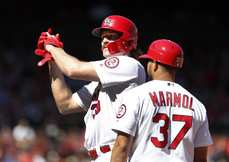 St. Louis Cardinals' Miles Mikolas celebrates after hitting an RBI single as first base coach Oliver Marmol (37) watches during the fourth inning of a baseball game against the San Francisco Giants Sunday, Sept. 23, 2018, in St. Louis. (AP Photo/Jeff Roberson)