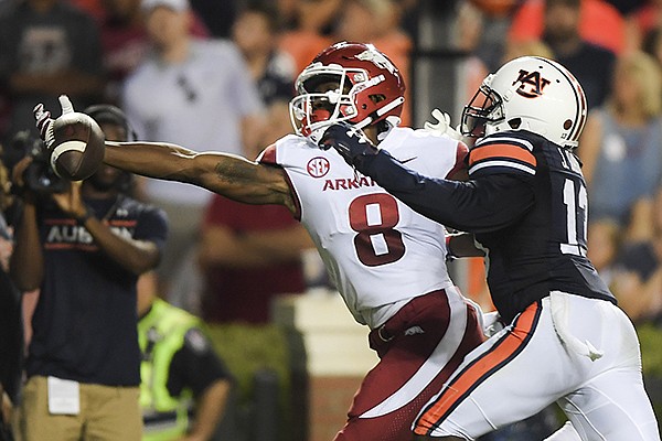 Arkansas Razorbacks wide receiver Michael Woods (8) misses a pass as Auburn Tigers defensive back Javaris Davis (13) puts pressure during the third quarter of a football game, Saturday, September 22, 2018 at Jordan-Hare Stadium in Auburn. Arkansas Razorbacks wide receiver Michael Woods (8) misses a pass as Auburn Tigers defensive back Javaris Davis (13) puts pressure during the third quarter of a football game, Saturday, September 22, 2018 at Jordan-Hare Stadium in Auburn.