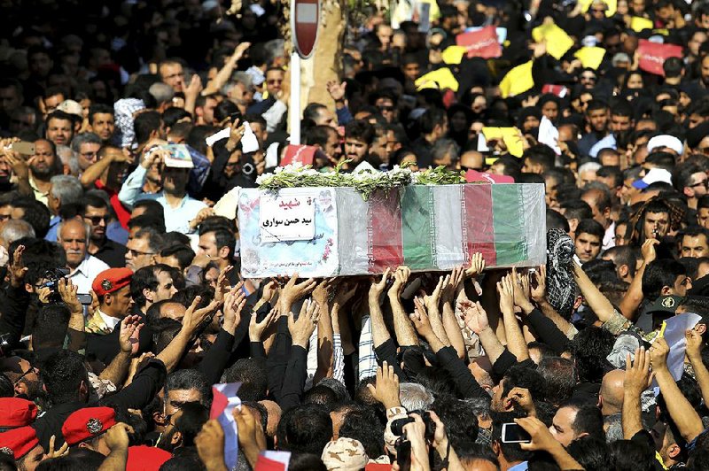 Mourners carry a casket of a victim of a terror attack on a military parade last week in Iran’s southwestern city of Ahvaz. Some 25 people were killed and thousands attended a mass funeral ceremony Monday in Ahvaz. Mourners gathered at the Sarallah Mosque on Ahvaz’s Taleghani junction, carrying victims’ caskets in the sweltering heat.