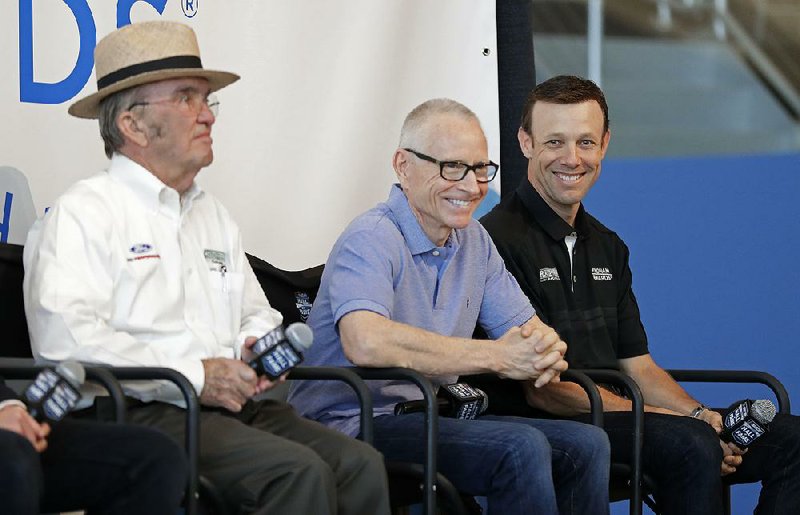 NASCAR driver Matt Kenseth, right, shares a laugh with team owner Jack Roush, left, and Mark Martin, center, during a news conference in Charlotte, N.C., Wednesday, April 25, 2018. Kenseth will return to NASCAR this season in a reunion with Roush Fenway Racing, the team that gave him his Cup start in 1998. Kenseth will split the No. 6 Ford with Trevor Bayne, who has been the full-time driver of that car since 2015.