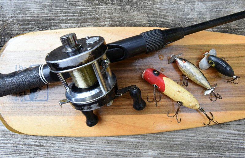 NWA Democrat-Gazette/FLIP PUTTHOFF Classic lures that still catch bass today include Bass Oreno (from left), Crazy Shad and Jitterbug. They're shown here with an Ambassadeur 5000 C reel the author bought used in 1976 that's still in use. The rod is a Lew's Speed Stick with pistol grip handle purchased new the same year.