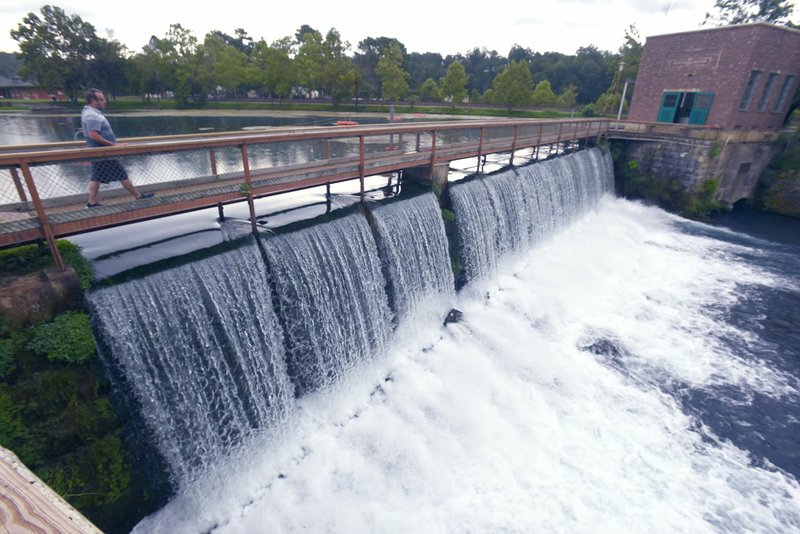 NWA Democrat-Gazette/FLIP PUTTHOFF Mammoth Spring flows over a dam at Mammoth Spring State Park to form the Spring River.