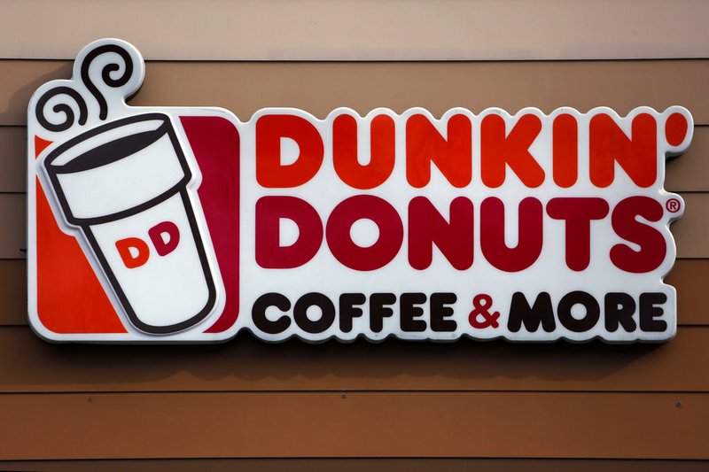 In this Jan. 22, 2018, file photo shows the Dunkin' Donuts logo on a shop in Mount Lebanon, Pa. Dunkin' is dropping the donuts — from its name, anyway. Doughnuts are still on the menu, but the company is renaming itself "Dunkin'" to reflect its increasing emphasis on coffee and other drinks. The change will officially take place in January 2019. (AP Photo/Gene J. Puskar, File)