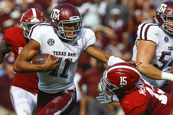 Texas A&M quarterback Kellen Mond (11) stiff arms Alabama defensive back Xavier McKinney (15) as he carries for a first down during the first half of an NCAA college football game, Saturday, Sept. 22, 2018, in Tuscaloosa, Ala. (AP Photo/Butch Dill)
