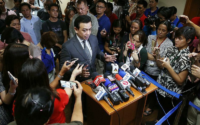 Sen. Antonio Trillanes IV speaks to reporters Tuesday outside his office in Manila after posting bail on rebellion charges that were reinstated after President Rodrigo Duterte revoked his amnesty. 

