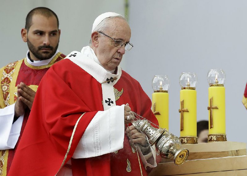 Pope Francis spreads incense Tuesday as he celebrates a Mass in Freedom Square in Tallinn, Estonia. 