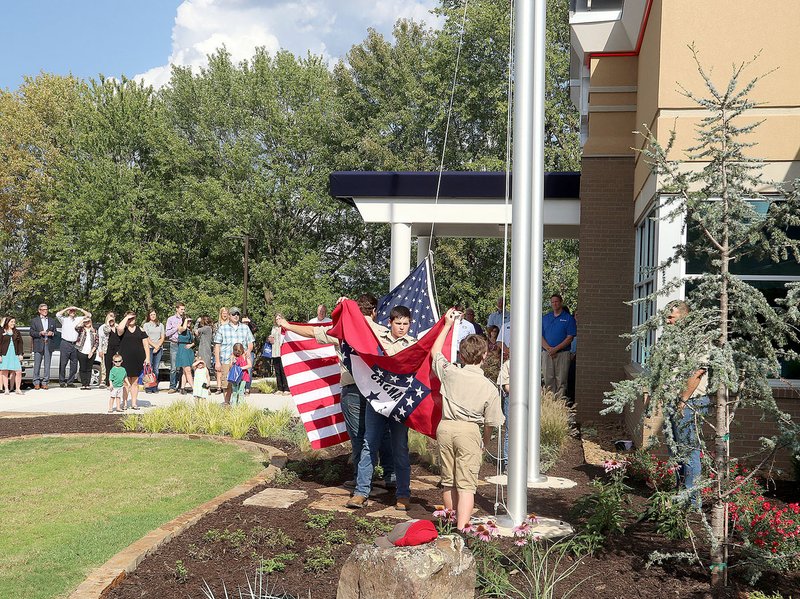 LYNN KUTTER ENTERPRISE-LEADER Prairie Grove's Boy Scout Troop posted the colors for the grand opening last week at Arvest Bank.