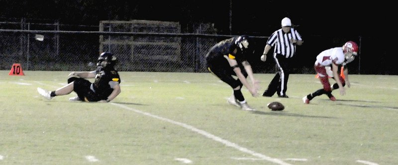 MARK HUMPHREY ENTERPRISE-LEADER Prairie Grove junior Graham Guenther scoops up a blocked punt, which he returned 8 yards for a touchdown during Friday's 63-0 win by the Tigers over conference newcomer Green Forest.