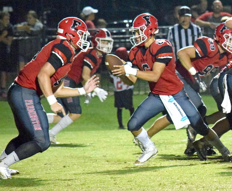 MICHAEL ECKELS NWA NEWSPAPERS Farmington senior quarterback Eric Hill hands off to tailback Reid Turner during a non conference contest. The Cardinals returned to the win column with a 38-13 victory at Clarksville Friday. Turner had two touchdowns and 196 yards rushing.