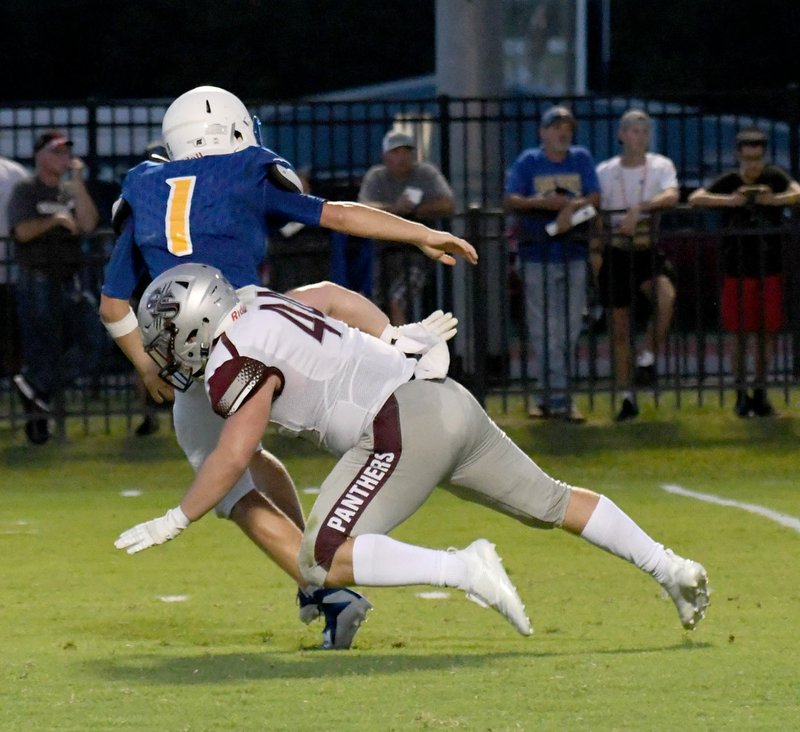 Bud Sullins/Special to the Herald-Leader Siloam Springs senior Matt Avery tackles Pryor (Okla.) quarterback Trapper Gilstrap during the Panthers' 38-21 season-opening win on Aug. 31 in Pryor.