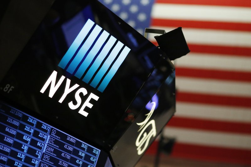 In this Dec. 27, 2017, file photo, a logo for the New York Stock Exchange is displayed above the trading floor.  (AP Photo/Mark Lennihan, File)