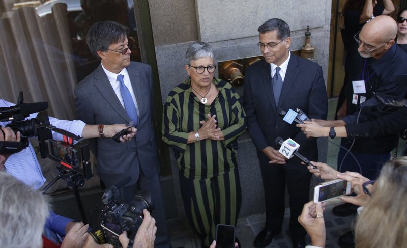 California leaders, from left to right, Cal/EPA Secretary Matthew Rodriguez, California Air Resources Board Chair Mary Nichols and California Attorney General Xavier Becerra talk to the media after speaking during the first of three public hearings on the Trump administration's proposal to roll back car-mileage standards in a region with some of the nation's worst air pollution Monday, Sept. 24, 2018 in Fresno, Calif.  (AP Photo/Gary Kazanjian)