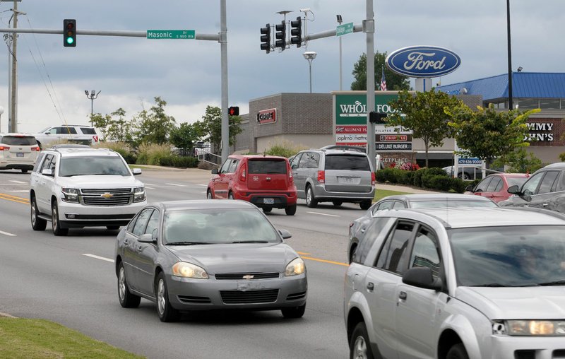 File photo/NWA Arkansas Democrat-Gazette/DAVID GOTTSCHALK Traffic moves Sept. 12 through the intersection of College Avenue and Masonic Drive in Fayetteville.