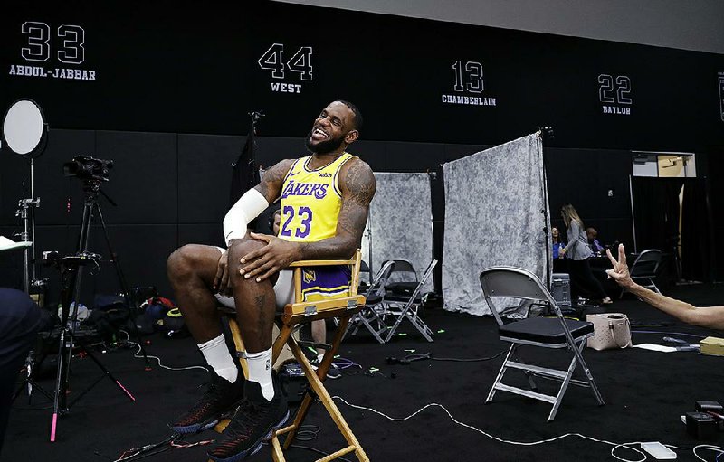 Los Angeles Lakers’ forward LeBron James smiles as he conducts an interview  during media day at the NBA basketball team’s practice facility Monday in  El Segundo, Calif. 