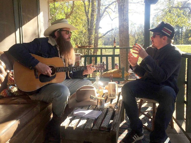 Ben Dickey, in costume as ill-starred singer-songwriter Blaze Foley, listens to director Ethan Hawke on the set of Blaze.
