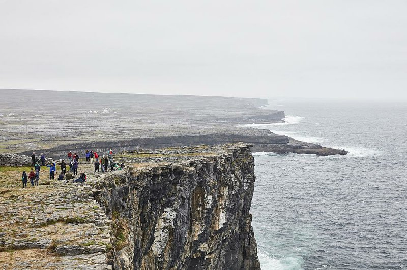 Tourists congregate on the Dun Aonghasa fort on Inishmore, one of several prehistoric hill forts on the Aran Islands. 